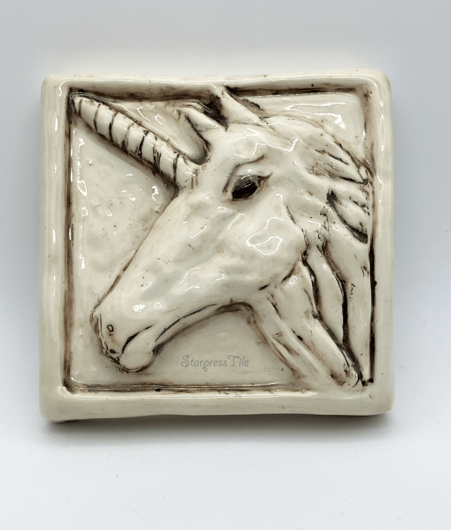 Relief Unicorn Ceramic Tile. Side view of detailed face.