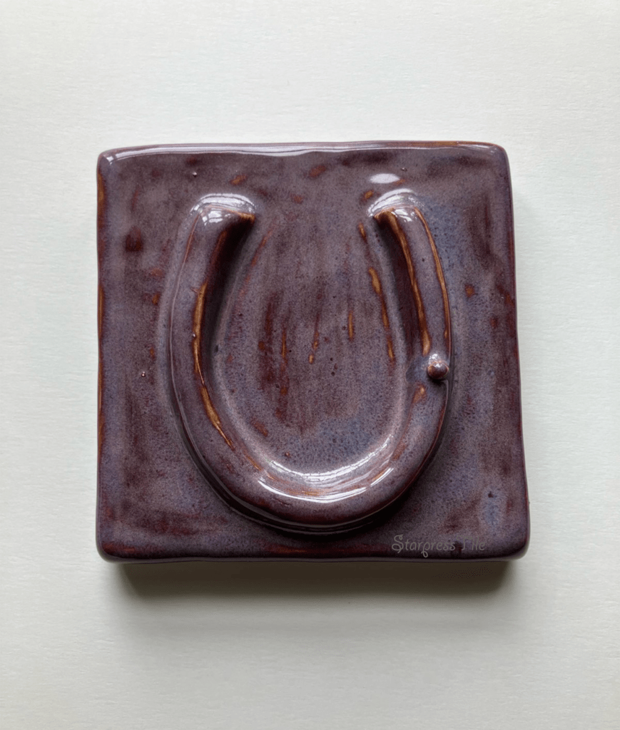 Purple Horseshoe Relief Ceramic Tile.